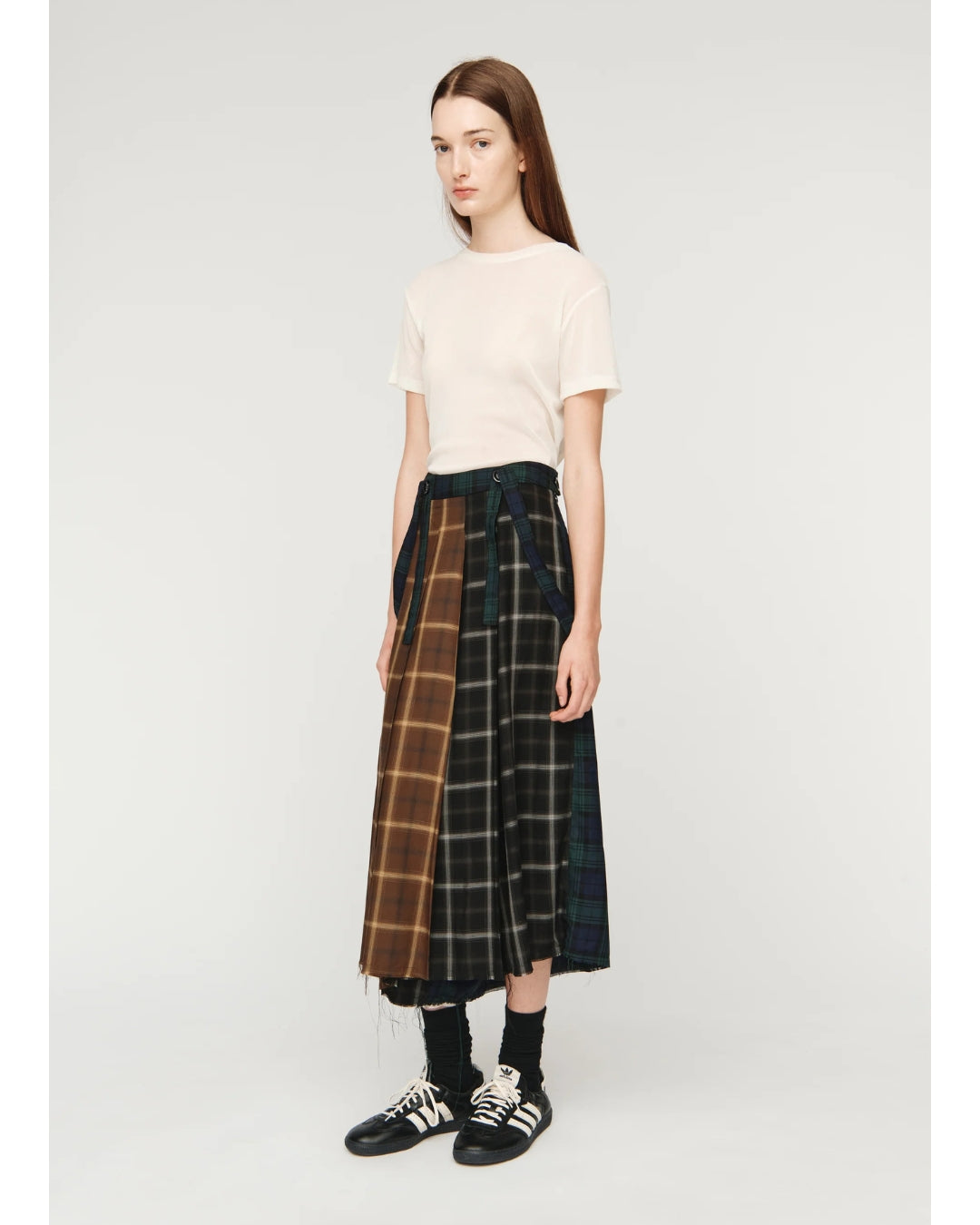 Song for the Mute Pleated Skirt, three-quarter view showing full silhouette and multi-tartan construction