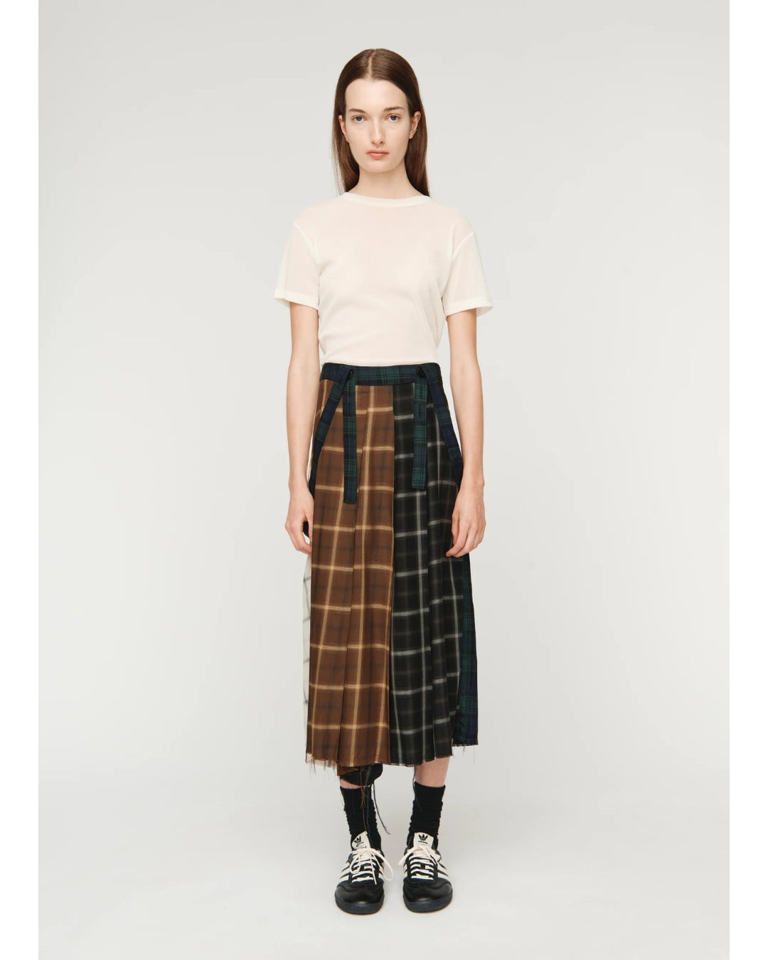 Song for the Mute Pleated Skirt, front view showing brown and dark check tartan panels