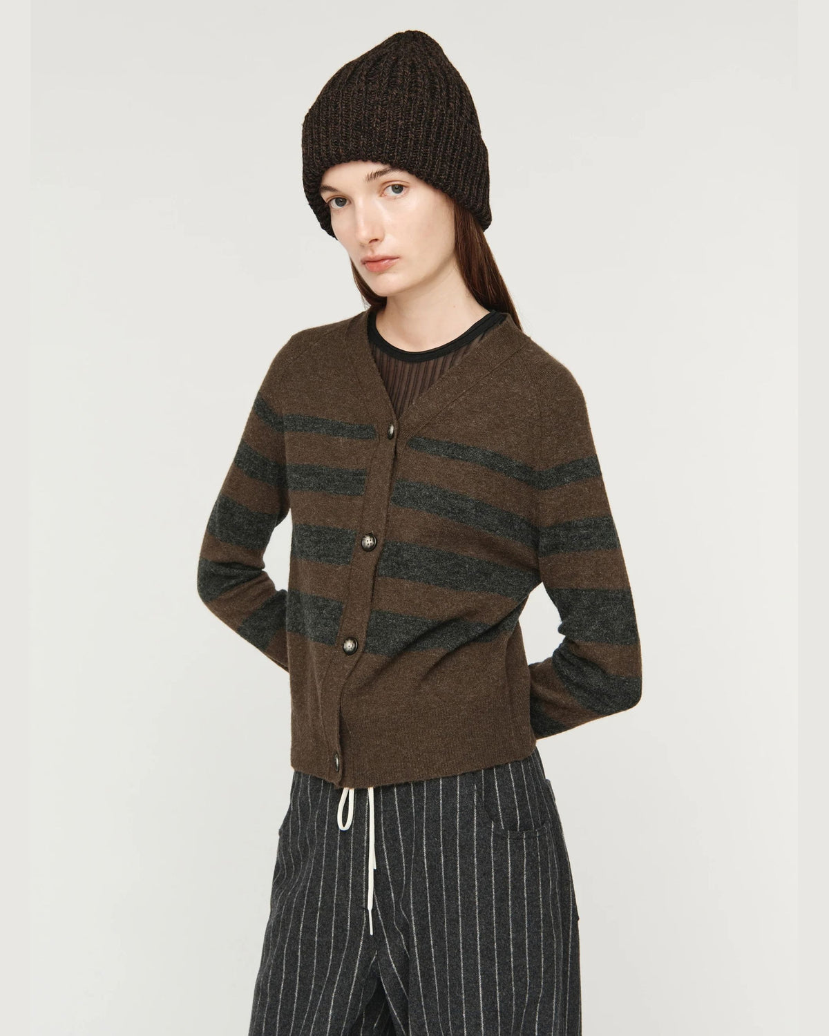 Song for the Mute Button Up Cardigan in Brown/Charcoal, close front view with hand at hip