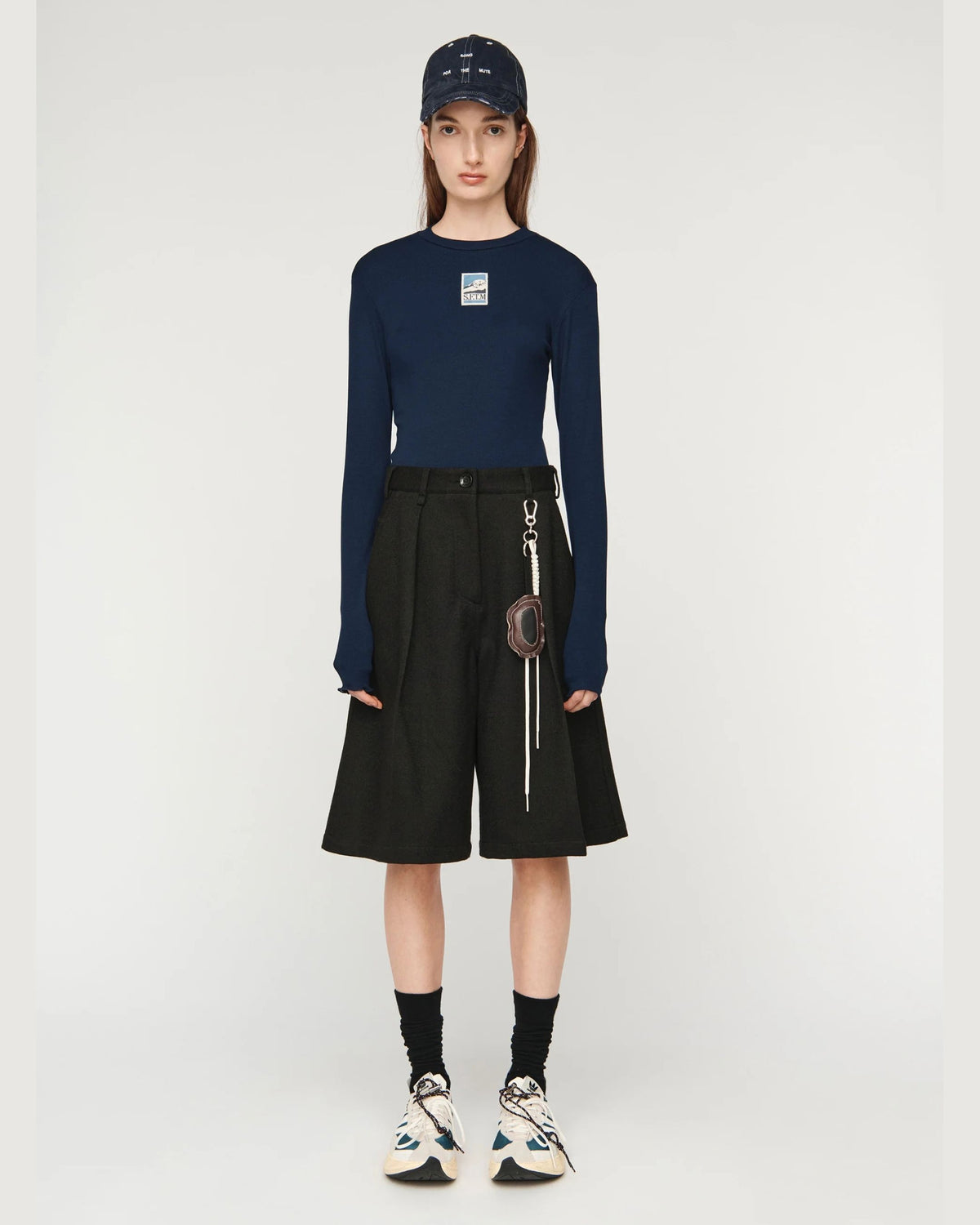 Song for the Mute Super Baggy Short in Petrol Black, front view on model with navy long sleeve top