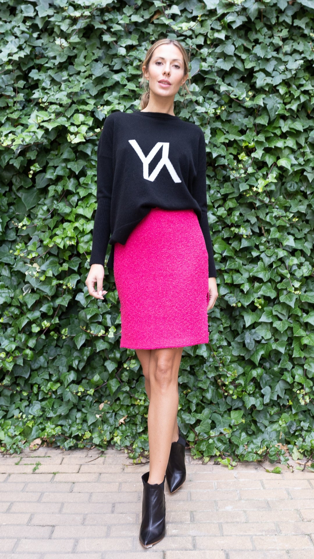 St. John Boucle Knit Skirt Hot Pink Mini Skirt Metallic Luxury Knitwear Experience 27 Madrid with side hem cut outs. Shown on model facing front.