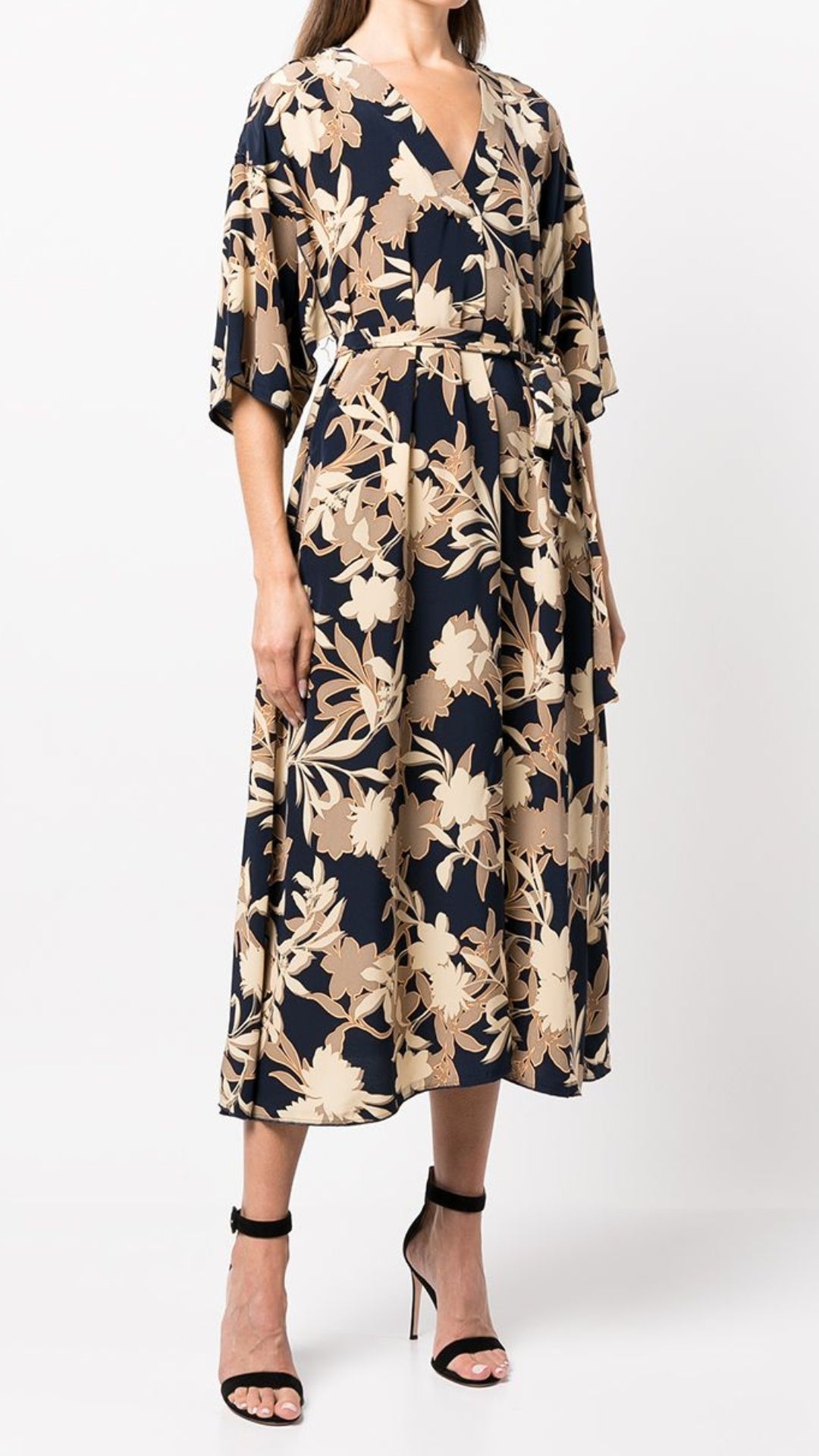 St John Knits Floral Print Silk Midi Dress. Kimono style dress in natural tones and navy blue. With a silk tie belt and half length sleeves. Midi length. Shown on model  facing front.