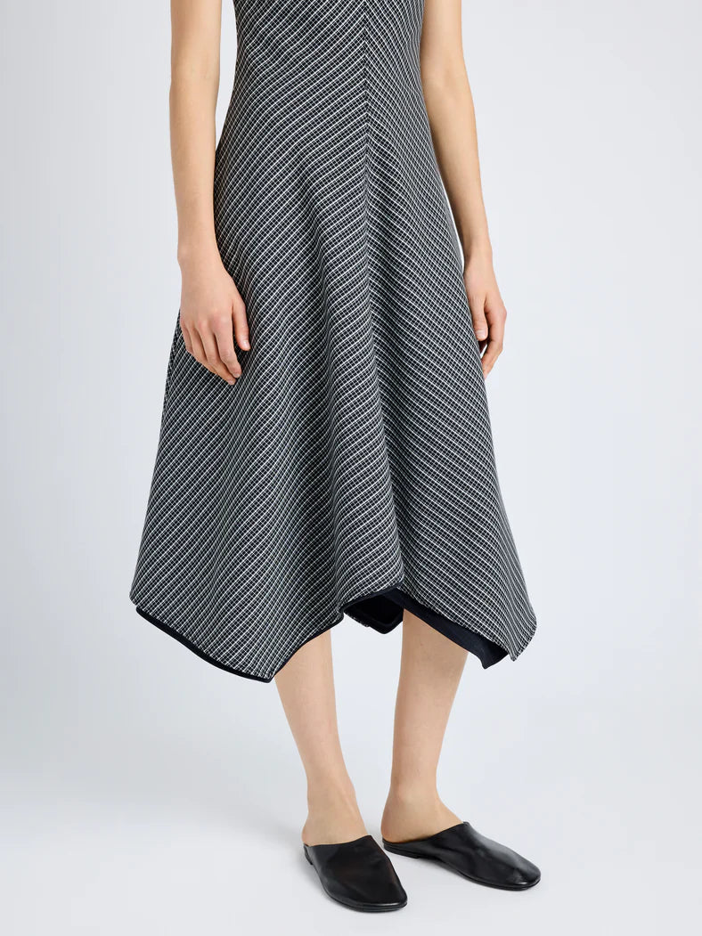 Black and white check print dress with V-neck, tailored bodice, A-line skirt, and asymmetrical hem, Proenza Schouler designer fashion.