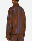 Wales Bonner Life Jacket Italian-made jacket crafted from lightweight herringbone wool in deep brown and blue stripe colors. This coat features long sleeves and a front zipper. Shown on model facing back and side.