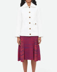 Wales Bonner Nile Skirt This A-line midi skirt features an elastic waist and beautiful pleats at the mid-thigh. Woven striped pattern in red and purples. The skirt falls to knee length. Shown on model facing front.