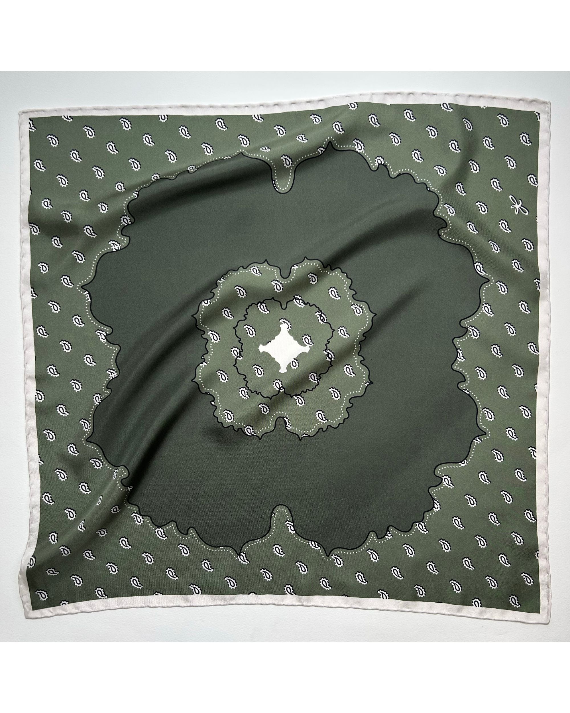 Square olive green silk scarf laid flat showing central paisley design