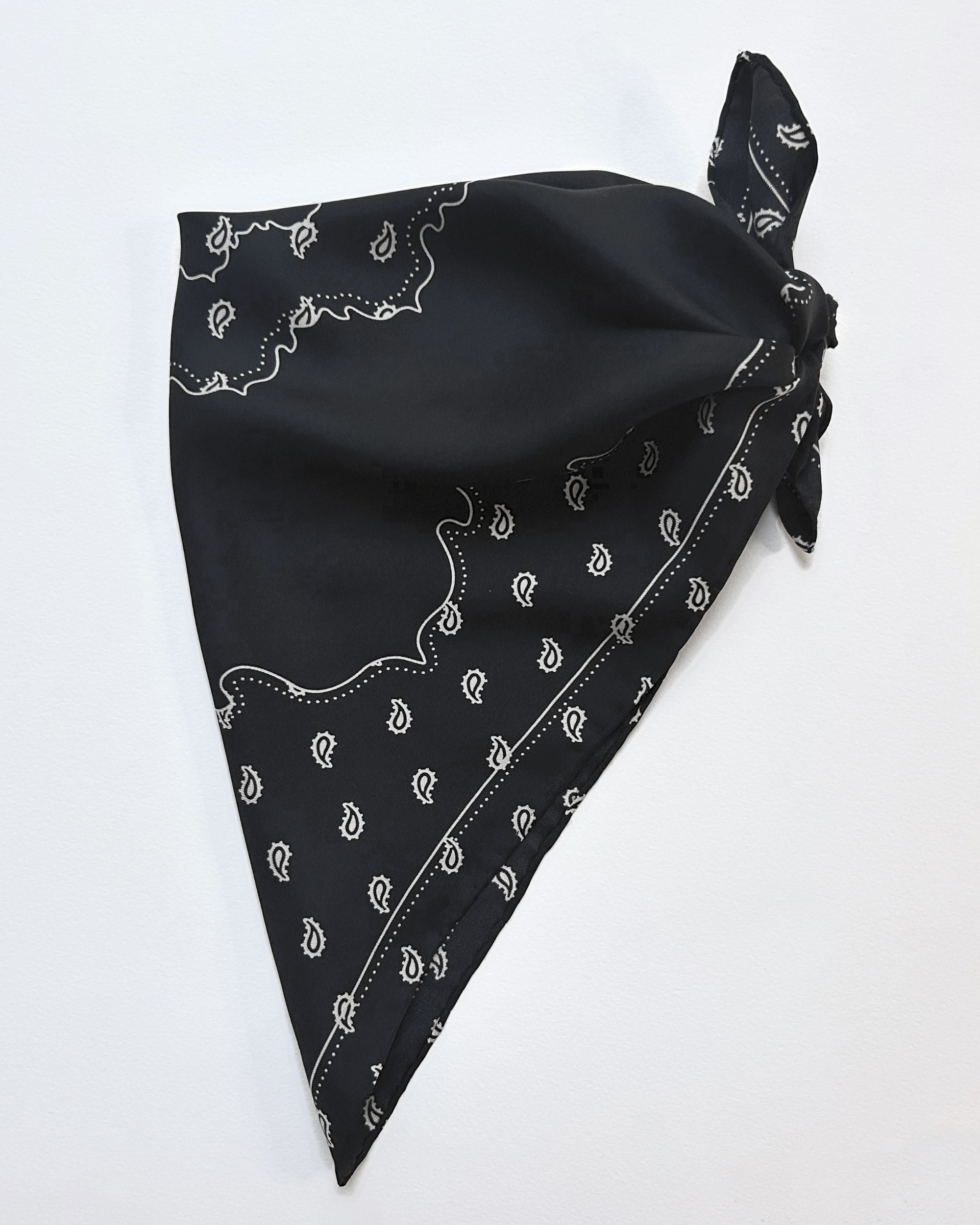 Black silk scarf tied with bandana motif
