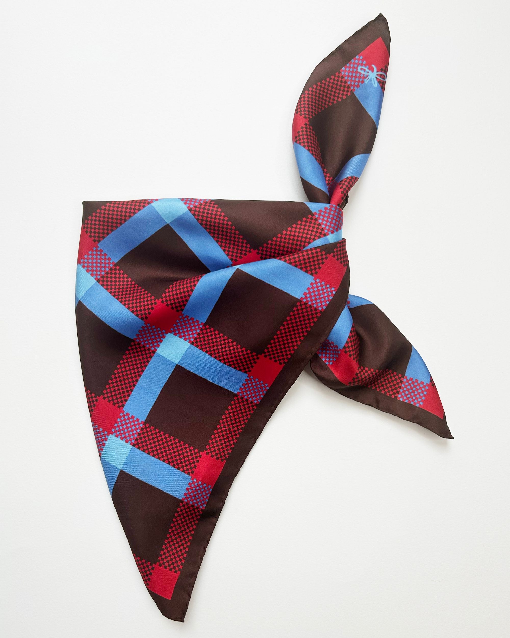 Brown silk scarf tied showing tartan design