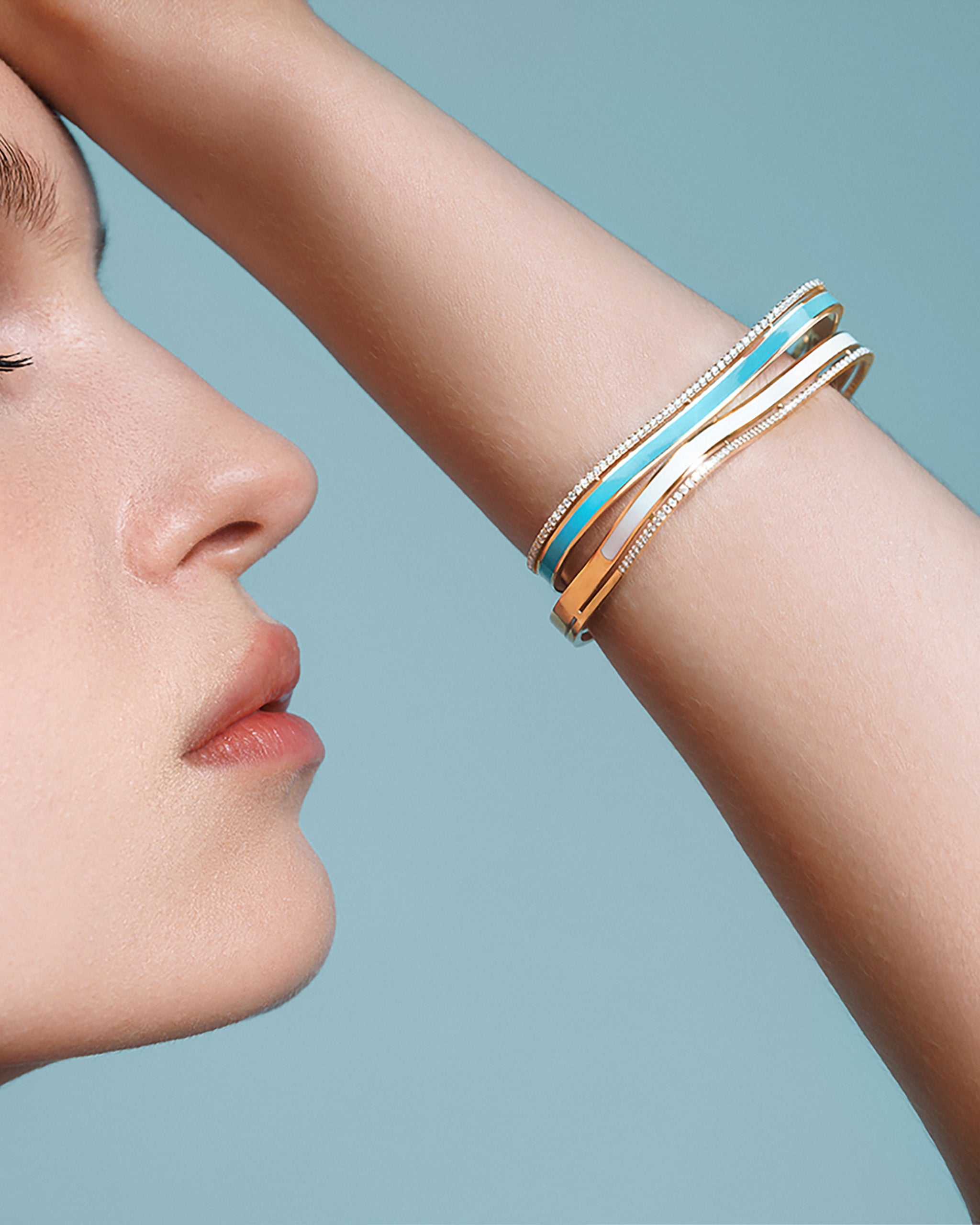 Sea Ice Bangle stacked on wrist — 18k gold with enamel and diamonds