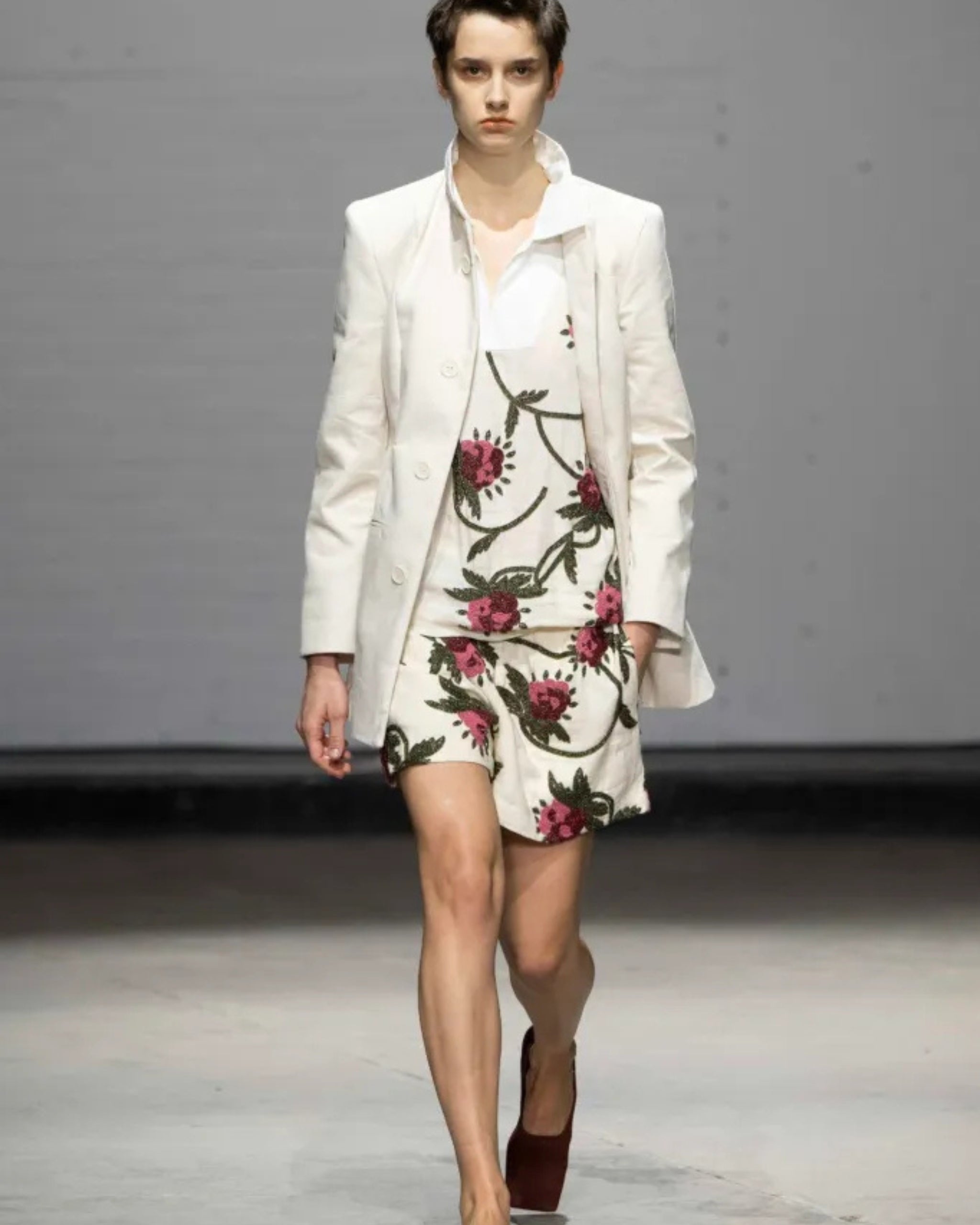Model wearing S.S. Daley Iona Beaded Rugby Shirt layered under white blazer on runway