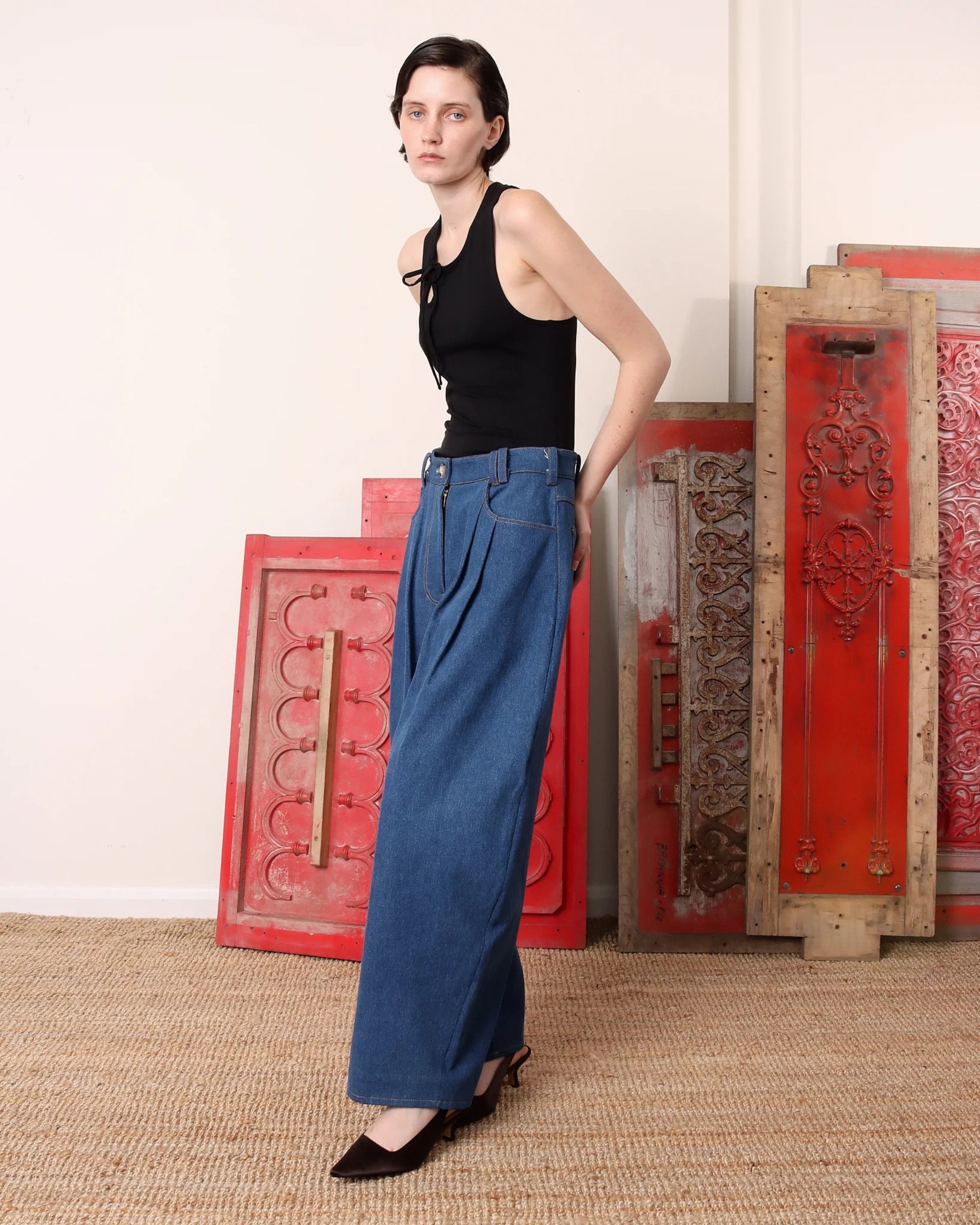 S.S. Daley wide-leg denim trousers in light blue — angled view highlighting pleats and fluid silhouette.