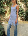 Dodo Bar Or Joe Long Top n Sky Blue. Hand crocheted in 100% cotton, this is a sleeveless style with rounded neck and low scooped back. The bottom hem is fringed. This photo shows the model wearing the blouse from the side.