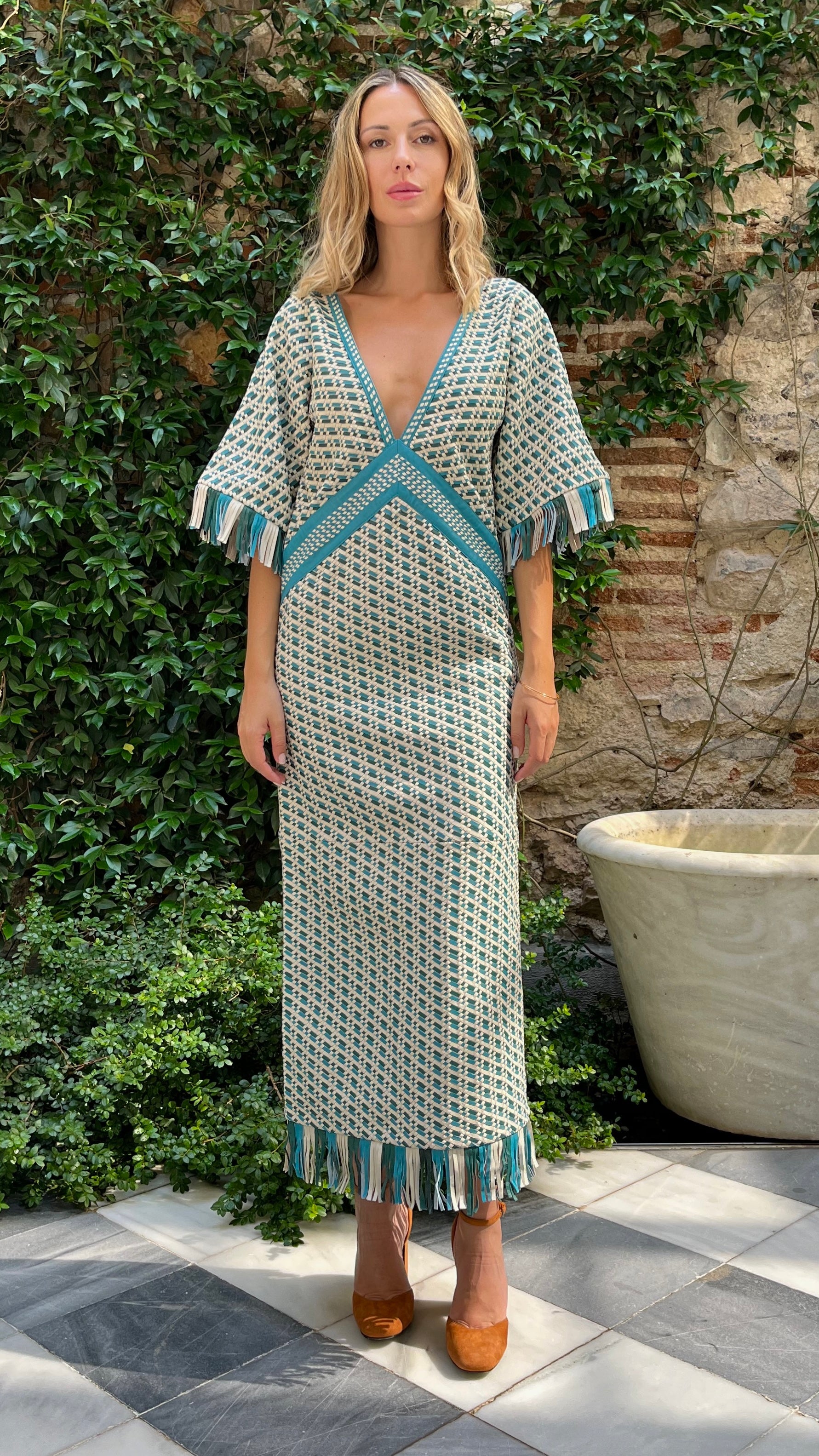 Dodo Bar Or Tor Dress Woven Lamb leather super luxurious dress. Deep v neck in blue green and cream. Slightly open v back. Midi length dress. Leather fringe detail. New collection Pre Fall experience 27. Shown in model front view.