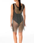 Leslie Amon Leslie Mini Net Dress in Black. Crafted from lightweight net material and encrusted with black rhinestones. Sleeveless and lands to mid knee length. Shown on the model facing back.