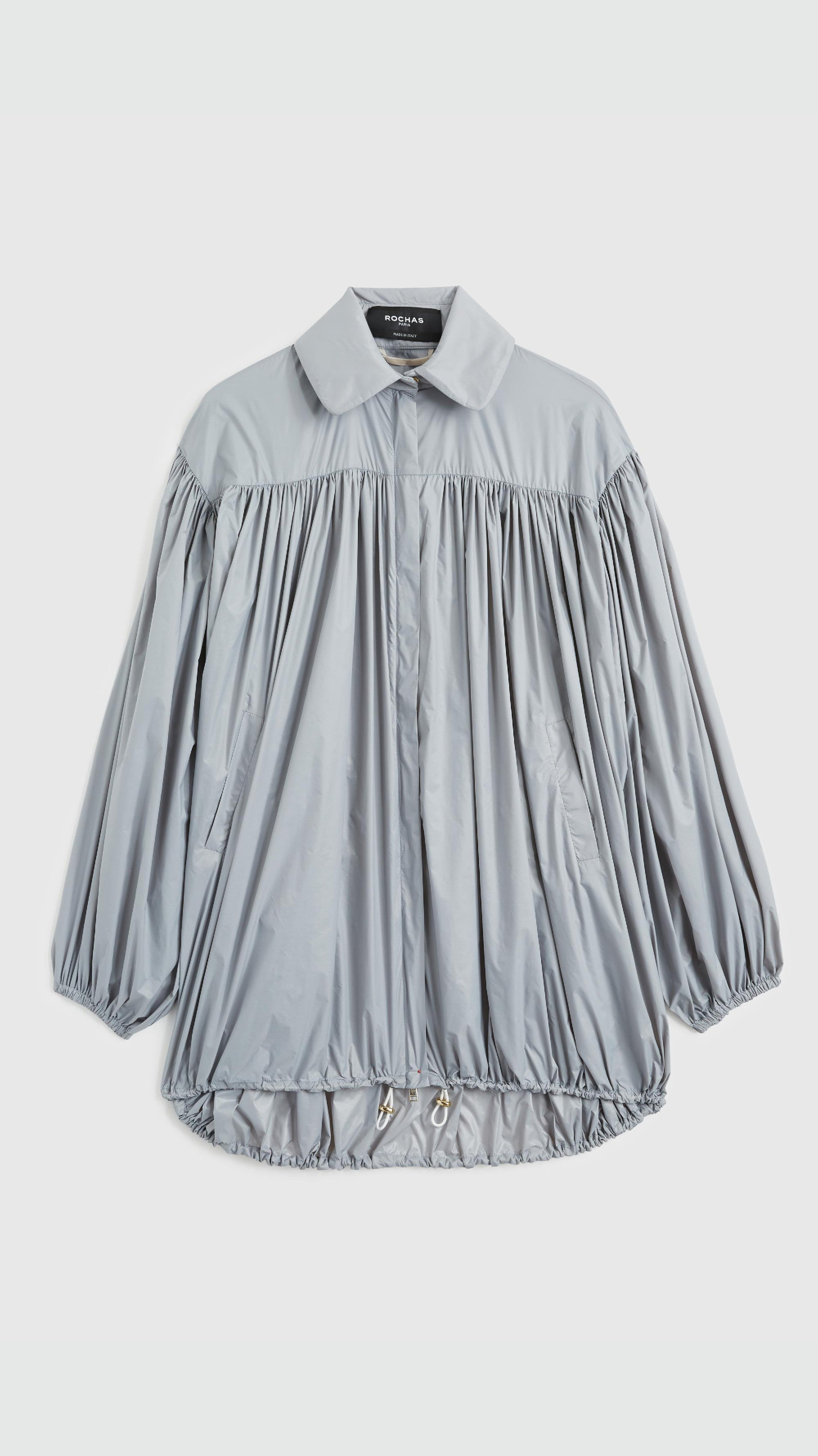 Rochas Paris Fashion Oversized Wind Jacket in a sky silver blue. Pleated draping across the front makes this elegant and luxurious outerwear jacket. Product photo shown from the front. 