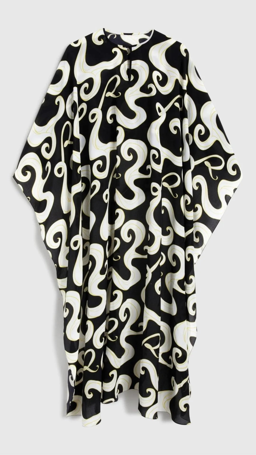 Rochas Paris Fashion Asymmetrical Fluid Top. With a waist length front and a dramatic caped back. Crafted in crepe de chine in a black and white pattern with yellow highlights. This is a product photo from the back.