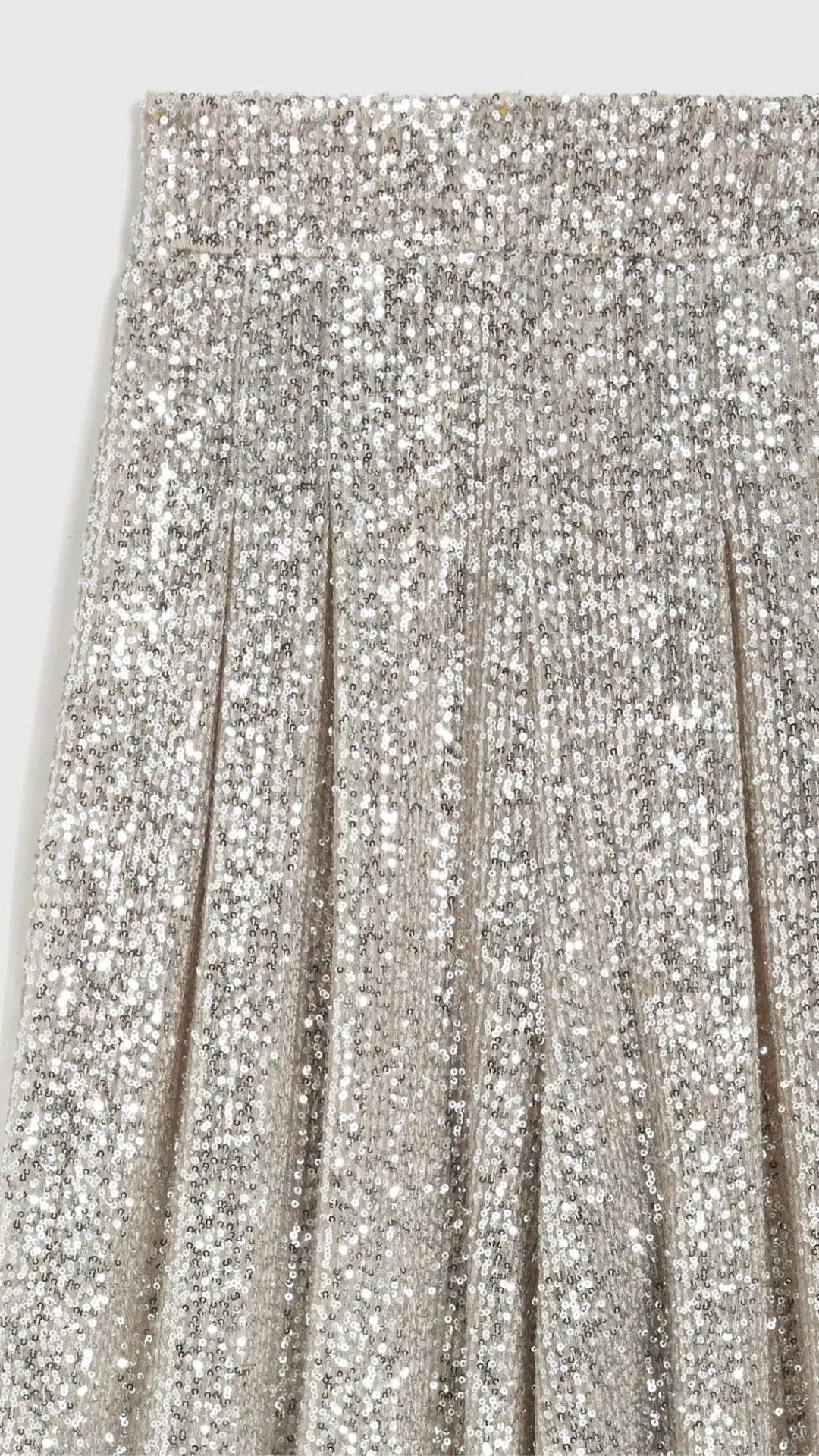 Rochas Paris Fashion High Waisted Sparkle Pants. Crafted in silver paillette sequins, they are tailored with a subtle front pleating and a fitted waist to create a slim, flattering silhouette. Product photo showcasing the detail of the sequins.