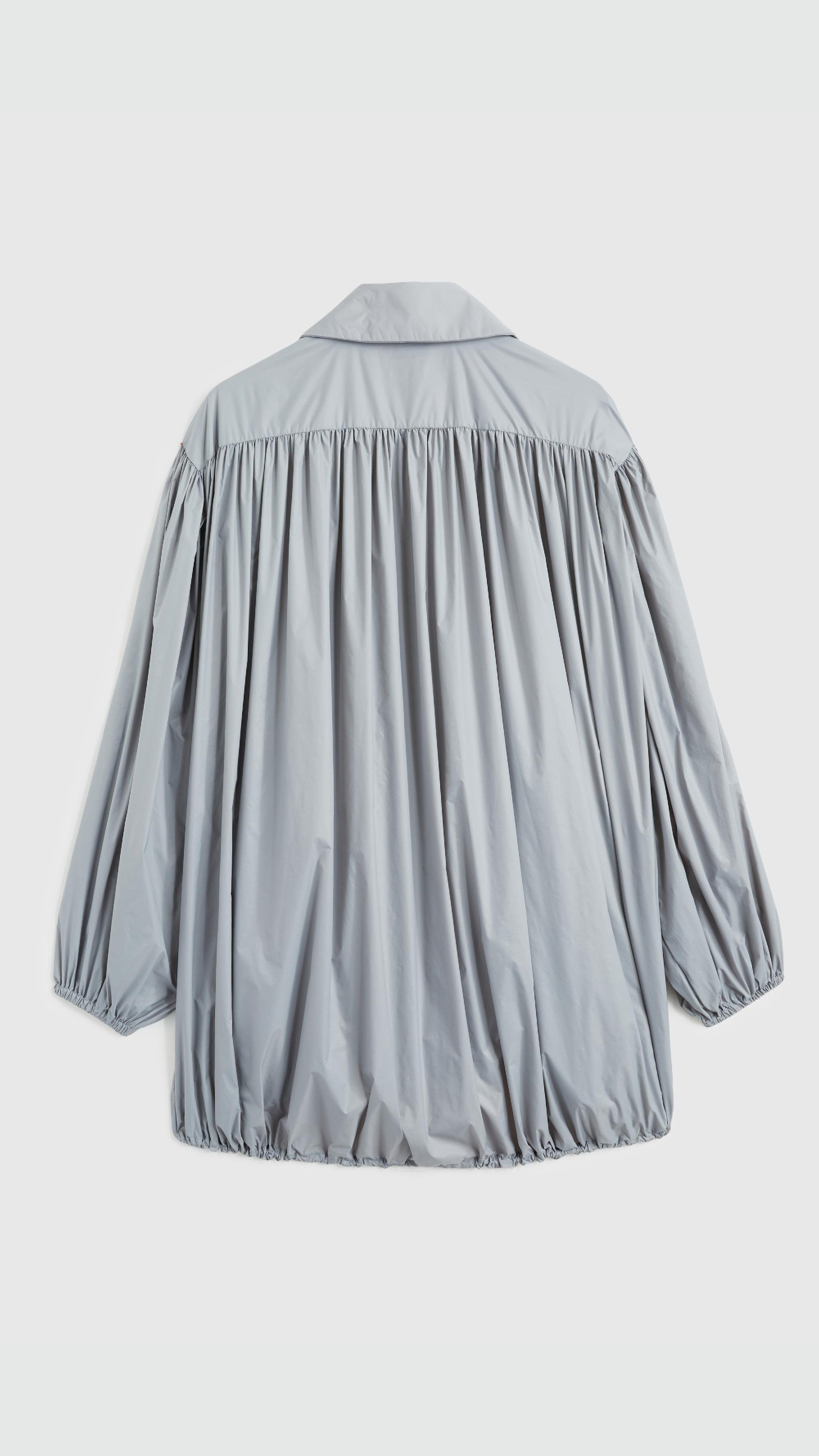 Rochas Paris Fashion Oversized Wind Jacket in a sky silver blue. Pleated draping across the front makes this elegant and luxurious outerwear jacket. Product photo shown from the back. 