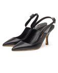 Rupert Sanderson Strabo Heel in Black Leather with Gold details. 75mm pumps classic style with an edge. Side front view showing pointed toe and adjustable ankle strap. Experience 27 Madrid. Luxury shoes.