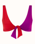Talia Collins The Bow Tie Top in Red and Plum. Sustainable swimwear made from recycled materials. Classic front tying bikini top in color block red and purple. V neck coverage bikini bathing suit top. Experience 27 Madrid. Product photo front view.