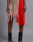 Thebe Magugu Shredded Pleated Skirt. Signature Thebe Magugu pleated skirt but with an asymmetrical twist in ecru, white and red. Shown on model facing forward.